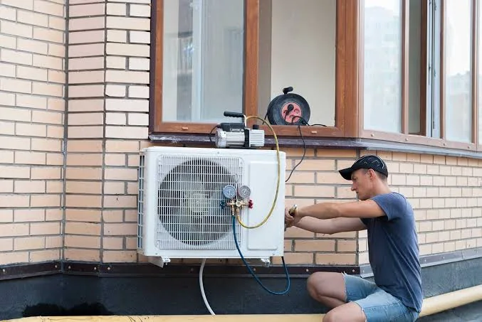 Technician installing an outdoor residential air conditioning unit
